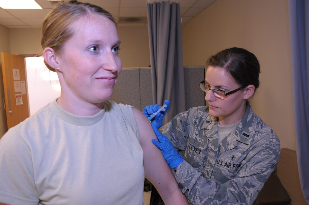 Spotting Measles Early: Signs Every Family Should Know Healthcare worker preparing a measles MMR vaccine dose at a community clinic